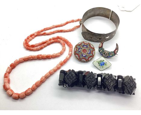 Charles Horner; A Chester Hallmarked Silver Buckle Bangle, of scrolling design, a carved coral necklace, each bead in the for