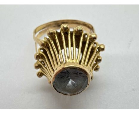 An Abstract Style Single Stone Ring, the circular centre stone collet set within high openwork setting with applied beaded su