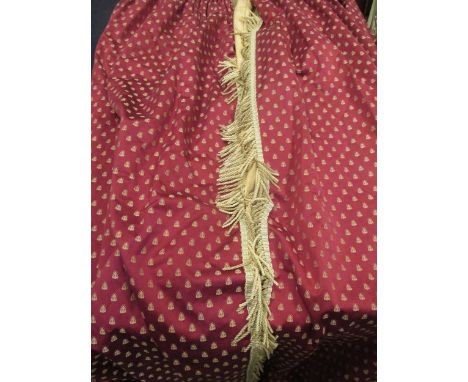 A pair of red curtains lined with yellow damask decorated with a repeating bee pattern and gold bullion tassels, each measure