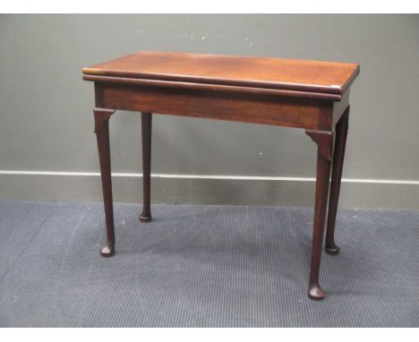 A 19th century mahogany fold over card table on lappet turned supports 76 x 91 x 45cm