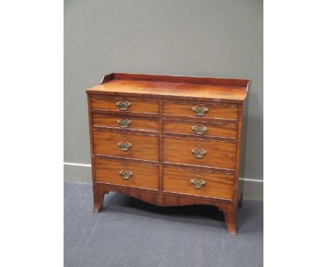 An early 19th century mahogany chest of drawers, with a raised gallery top, over eight drawers on splayed bracket feet 84 x 9