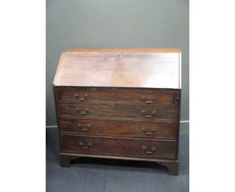 A George III mahogany bureau, the fall front enclosing a fitted interior, with four long graduating drawers on bracket feet 1