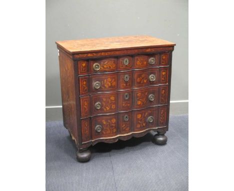 A Dutch marquetry commode with four long graduating drawers, a shaped apron on bun feet, 82 x 78 x 46cm