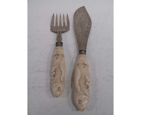 A pair of aesthetic movement silver fish servers, the large blade and fork pierced decorated with Japanesque scenes, the ivor