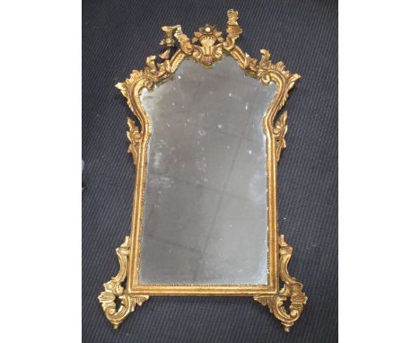 A mahogany Vauxhall type mirror, 63 x 43cm; a giltwood mirror in George II style, with acanthus cresting, 99 x 56cm (2)