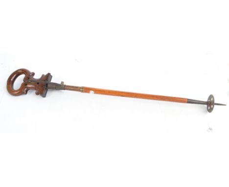 A late 19th century/early 20th century shooting stick with walnut hinged seat spring action and spiked ferrule, length 87cm.