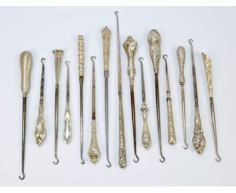 Fifteen medium sized button hooks with hallmarked silver sheath handles, including a wrythen linear example, a hexagonal exam