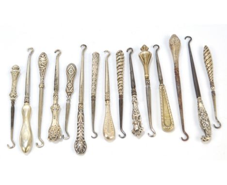 Fifteen small button hooks with hallmarked silver sheath handles, including a hammered example, an example decorated with a s