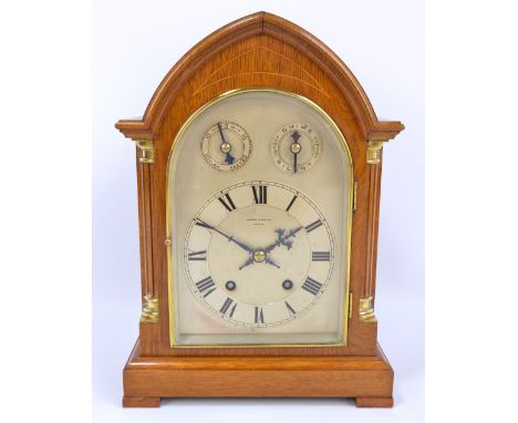 A Fattorini & Sons Ltd oak cased mantel clock, the silver chapter ring set with Roman numerals beneath slow/fast and chime/si
