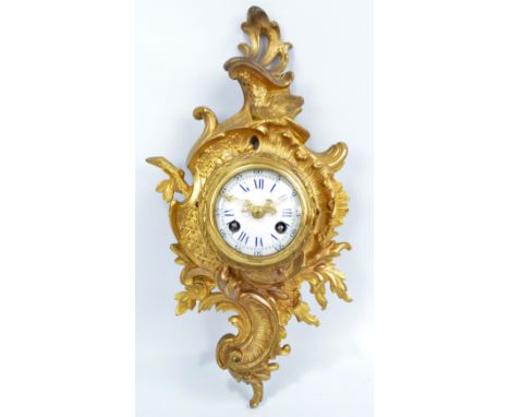 A late 19th century French ormolu rococo style eight day cartel clock, the circular enamel dial set with Roman numerals and A