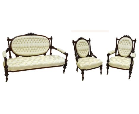 A good Victorian walnut three piece salon suite, the settee with oval button back and button seat above block fluted and carv