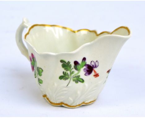 A circa 1800 Worcester cream jug with wrythen moulded body, painted with floral sprays, length 12cm.