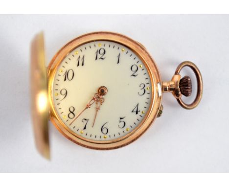 A continental 14ct gold crown wind fob watch with white enamel dial set with Arabic numerals and foliate decoration to the ca