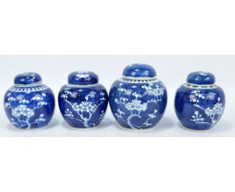 Four 20th century Chinese blue and white prunus decorated jars and covers, the largest height 14.5cm, all with blue double ri