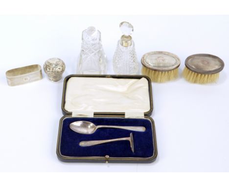 A George V hallmarked silver napkin ring of rounded rectangular form, Birmingham 1919, a pair of silver backed brushes, two s