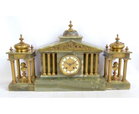 A late 19th century/early 20th century French three piece mantel clock garniture comprising an onyx and gilded brass mantel c
