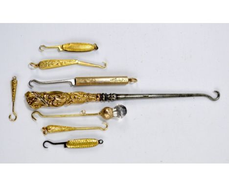 A collection of small gold button hooks, probably for gloves, all with hooks for use with a chatelaine, comprising an 18ct ye