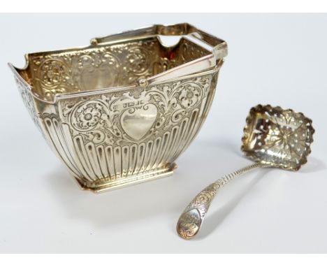 ATKIN BROS; a Victorian hallmarked silver sugar basket with repoussé foliate scrolling and heart shaped cartouche, with prese