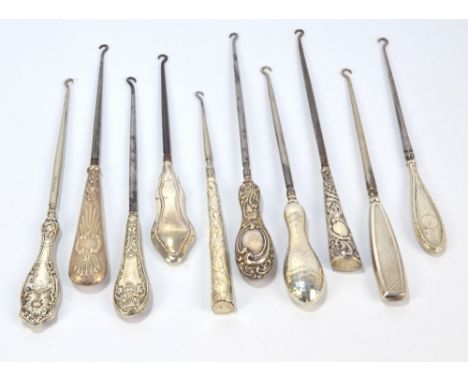 Ten large button hooks with hallmarked silver sheath handles, including engine turned decorated examples, an Art Nouveau exam