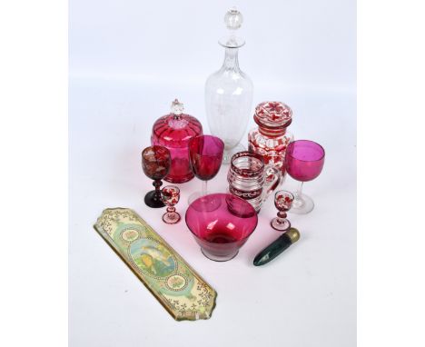 A small group of clear and ruby glass to include a small decanter with a pair of matching tot glasses, a green glass faceted 
