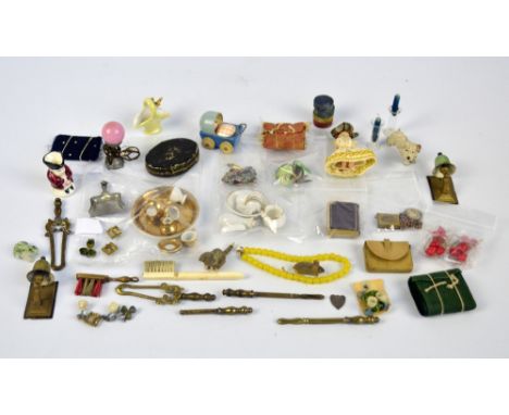 A quantity of doll and doll house accessories to include leather purse, miniature gilt and enamel book with internal sepia im