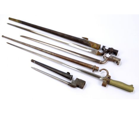 Four socket bayonets, one with leather scabbard, two with metal scabbard, one lacking scabbard, length of largest 66cm (4).  