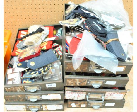 A quantity of Army, Navy and RAF shoulder flashes, cloth and bullion work badges; also numerous ribbon rolls.   CONDITION REP