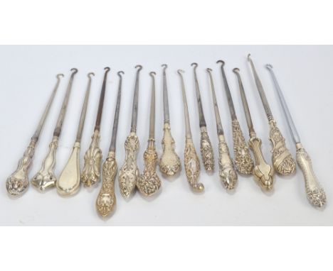 Fifteen medium sized button hooks with hallmarked silver sheath handles, including a stylised flower head example, a trilobe 