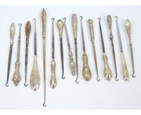 Fifteen medium sized button hooks with hallmarked silver sheath handles, including engine turned example, wrythen linear exam