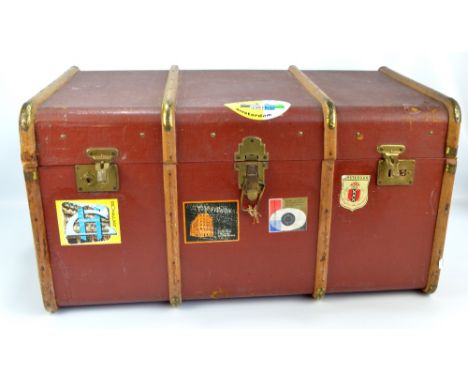 A vintage travelling trunk with hinged lid, canvas string handles and brass fittings, width 90cm.   CONDITION REPORT:  Areas 