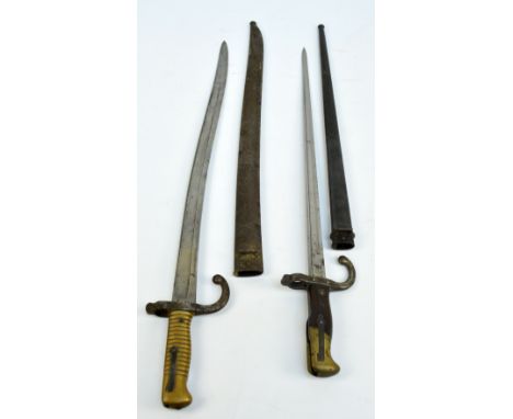 Two 19th century sword bayonets, the larger stamped J 13988 to quillon and scabbard, blade engraved with manufacturer's mark 