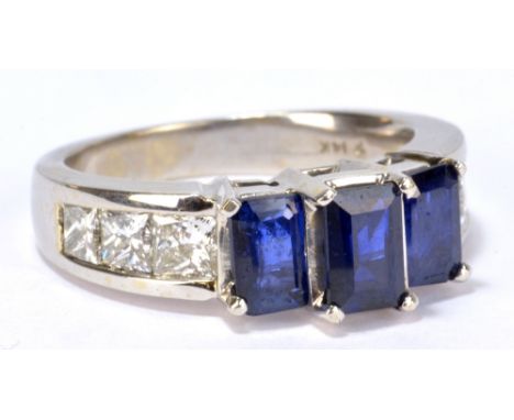 A 14ct white gold sapphire and diamond ring with three emerald cut sapphires totalling approx 1.5ct and six graduated princes