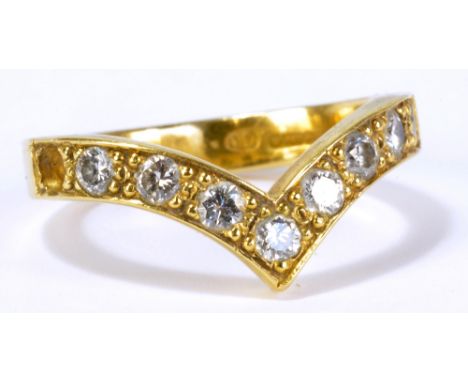 An 18ct yellow gold wishbone shaped ring with eight round cut diamonds in bead setting, each approx 0.07ct (one stone missing