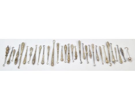 Eleven small button hooks, probably for gloves, with sterling and continental silver sheath handles, and a further quantity o