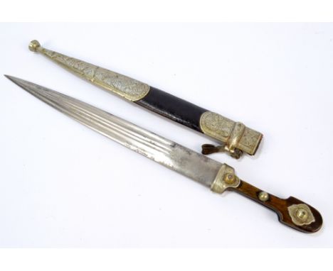 A 19th century dirk with shaped wooden grip, fluted engraved blade and leather scabbard with engraved plated mounts, overall 