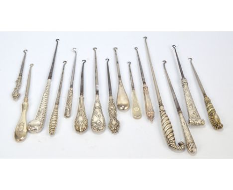Fourteen large and medium sized button hooks with hallmarked silver sheath handles, including a gilt washed curving example, 