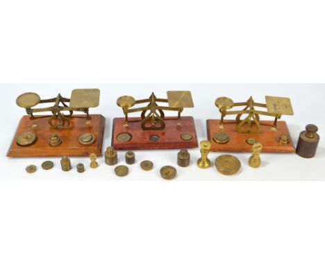 Three vintage sets of scales and a number of weights and measures.