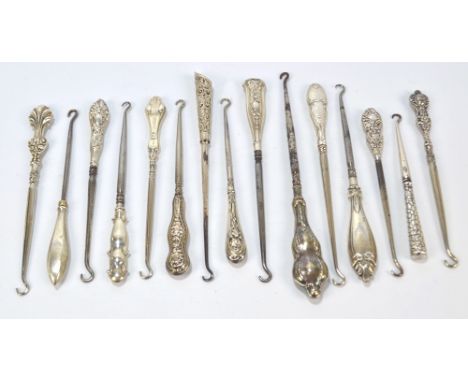 Fifteen small button hooks with hallmarked silver sheath handles, including an example decorated with irises, a tapering exam