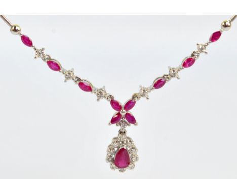 An 18ct white gold ruby and diamond necklace set with eight marquis cut rubies alternating melee diamonds suspending a pear c