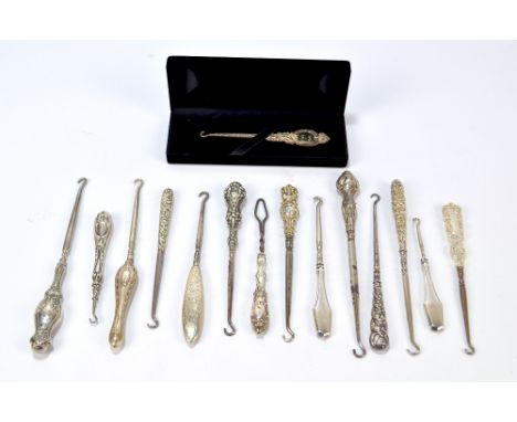 Eleven small button hooks with sterling silver sheath handles, including floral examples, plain shaped examples, three small 