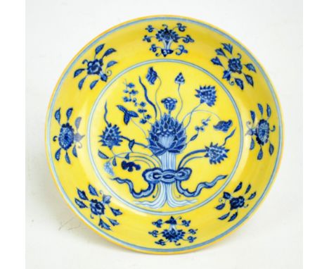 A Chinese porcelain circular shallow bowl painted in underglaze blue with floral sprays, with over glazed painted yellow grou