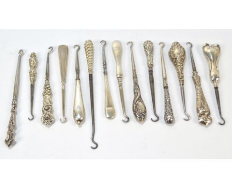 Fifteen small button hooks with hallmarked silver sheath handles, including an Art Nouveau shaped example with floral decorat
