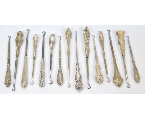 Fifteen medium sized button hooks with sterling silver sheath handles, including Art Nouveau examples with female heads, flow