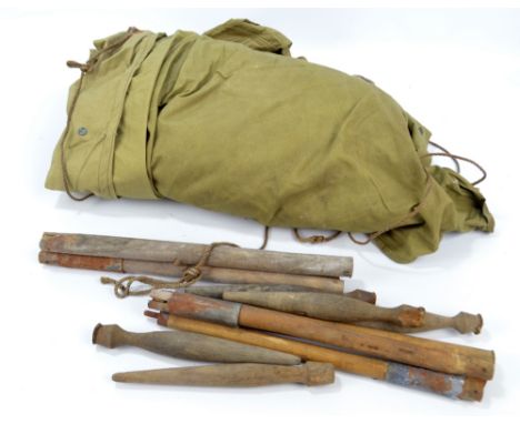 A WWII US Army tent with stamp for American Lady Corset Co. 1942, with contemporary wooden pegs.   CONDITION REPORT:  One fla