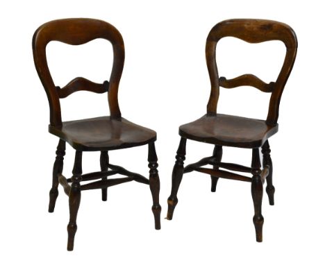 A set of eight 19th century beech balloon back dining chairs with saddle seats and ring turned front legs to peg feet.