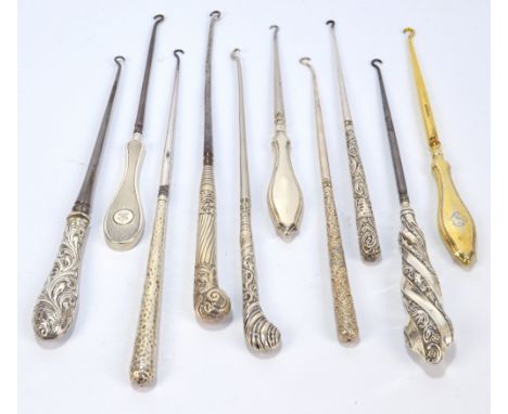 Ten large button hooks with hallmarked silver sheath handles, including a silver gilt example with monogram, an engine turned