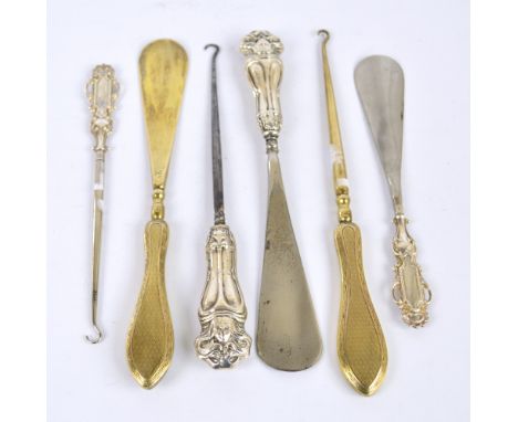 A George V hallmarked silver gilt sheath handled set of button hook and shoe horn with engine turned decoration, Charles Dome