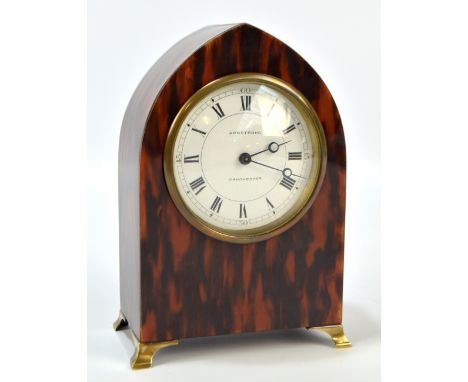 An early 20th century tortoiseshell lancet shaped mantel time piece with circular white enamel dial set with Roman numerals '