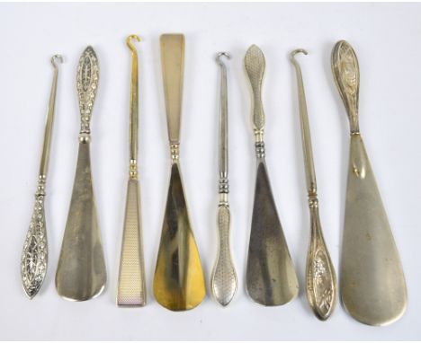 A George V hallmarked silver sheath handled set of shoe horn and button hook decorated with butterflies, W.J. Myatt & Co, Che