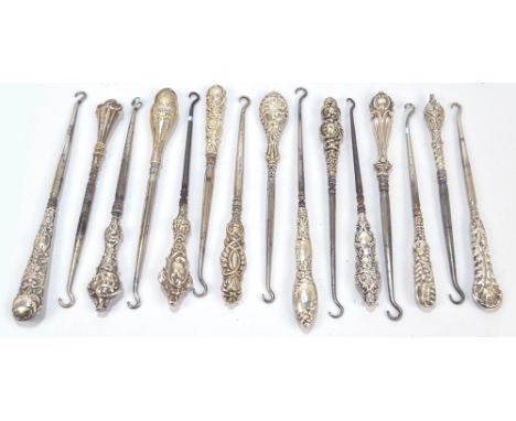 Fifteen small button hooks with hallmarked silver sheath handles, including a scrolling Art Nouveau example, an example with 